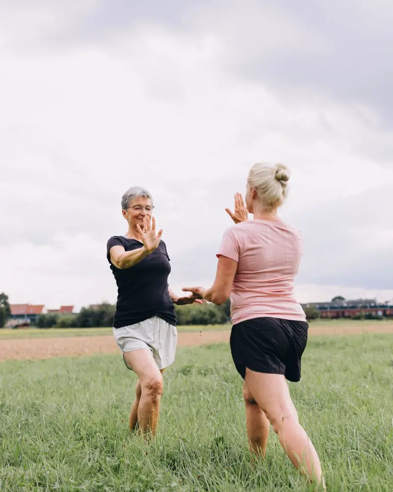 two women practicing martial arts for people over 50