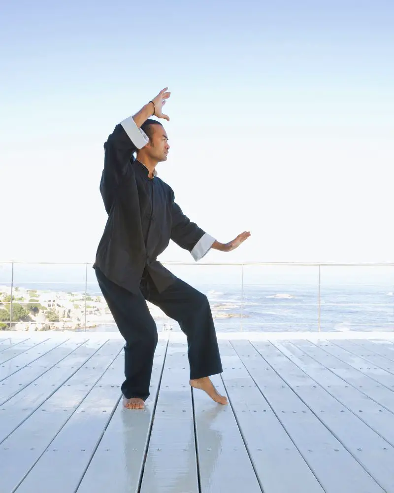 a man doing tai chi on a deck after discovering martial arts for people over 50