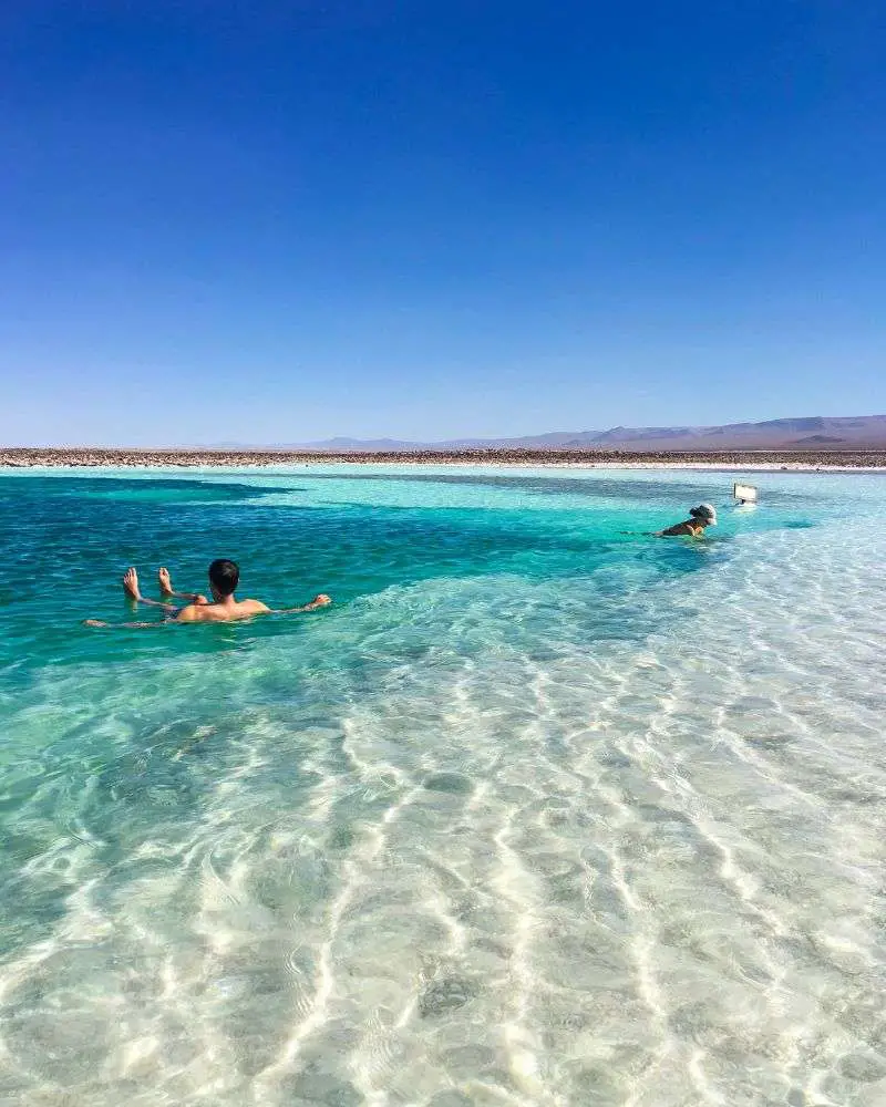 a man and woman swimming in clear water on one of many over 50 singles resorts