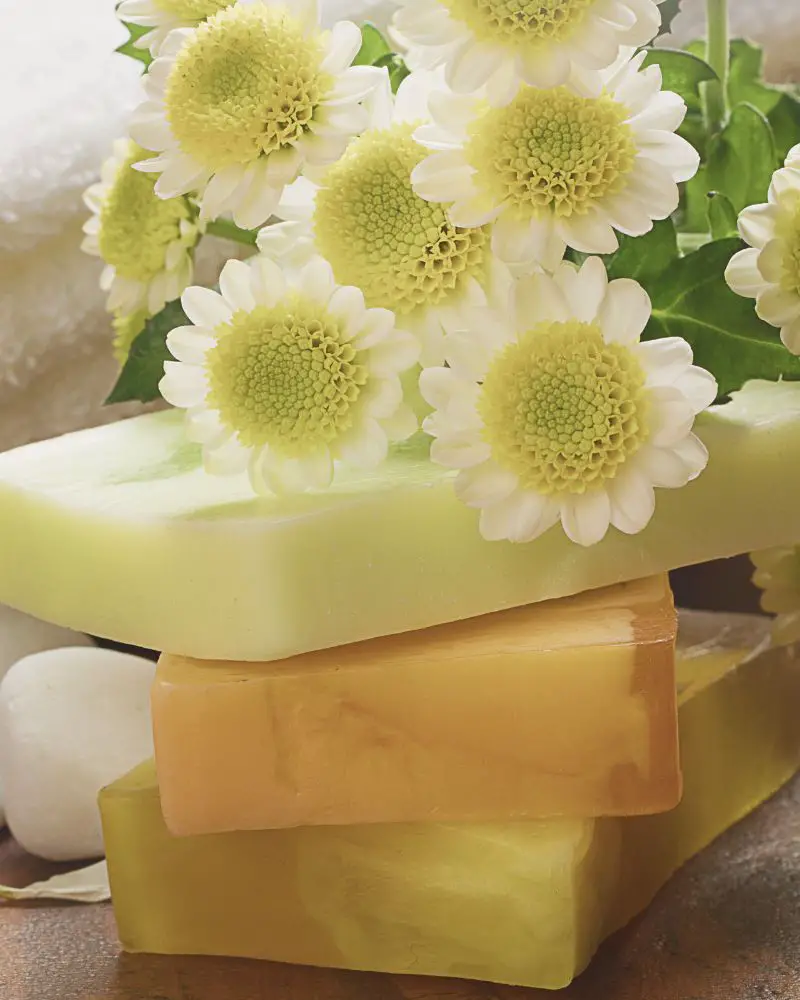 a stack of soaps with flowers from someone who is knowledgeable about selling handmade soap regulations