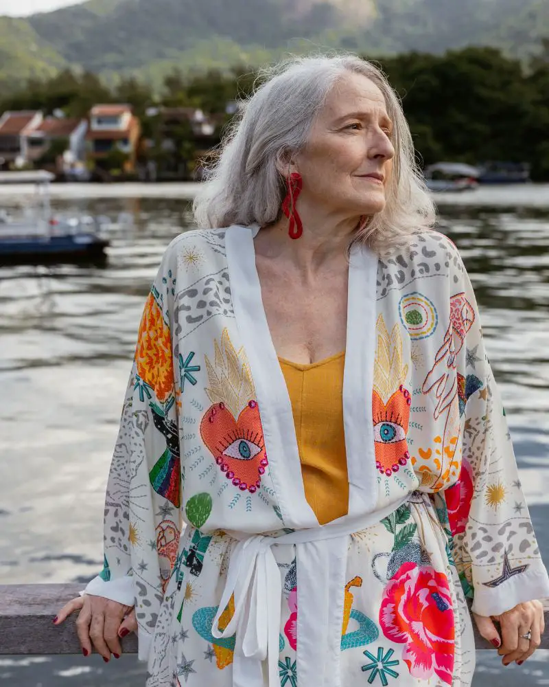 a woman standing on a dock near water