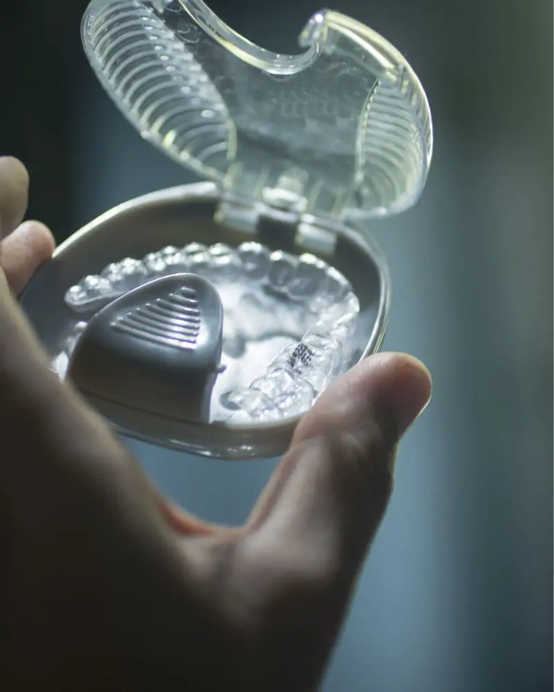 a hand holding a transparent plastic case