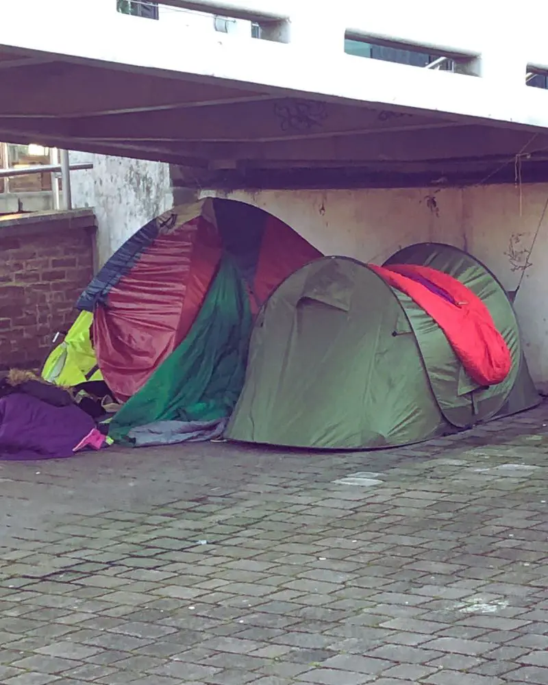 a group of tents under a bridge where homeless people must live