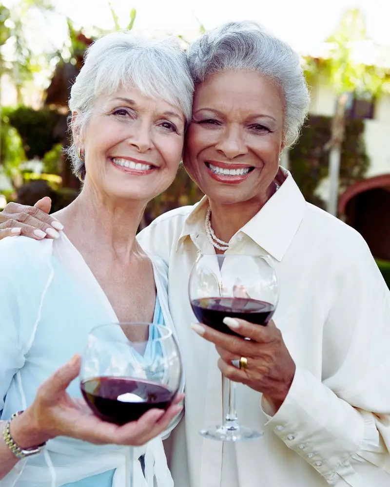 a group of women over 60 holding wine glasses and demonstrating that they are more than just grannies over 60