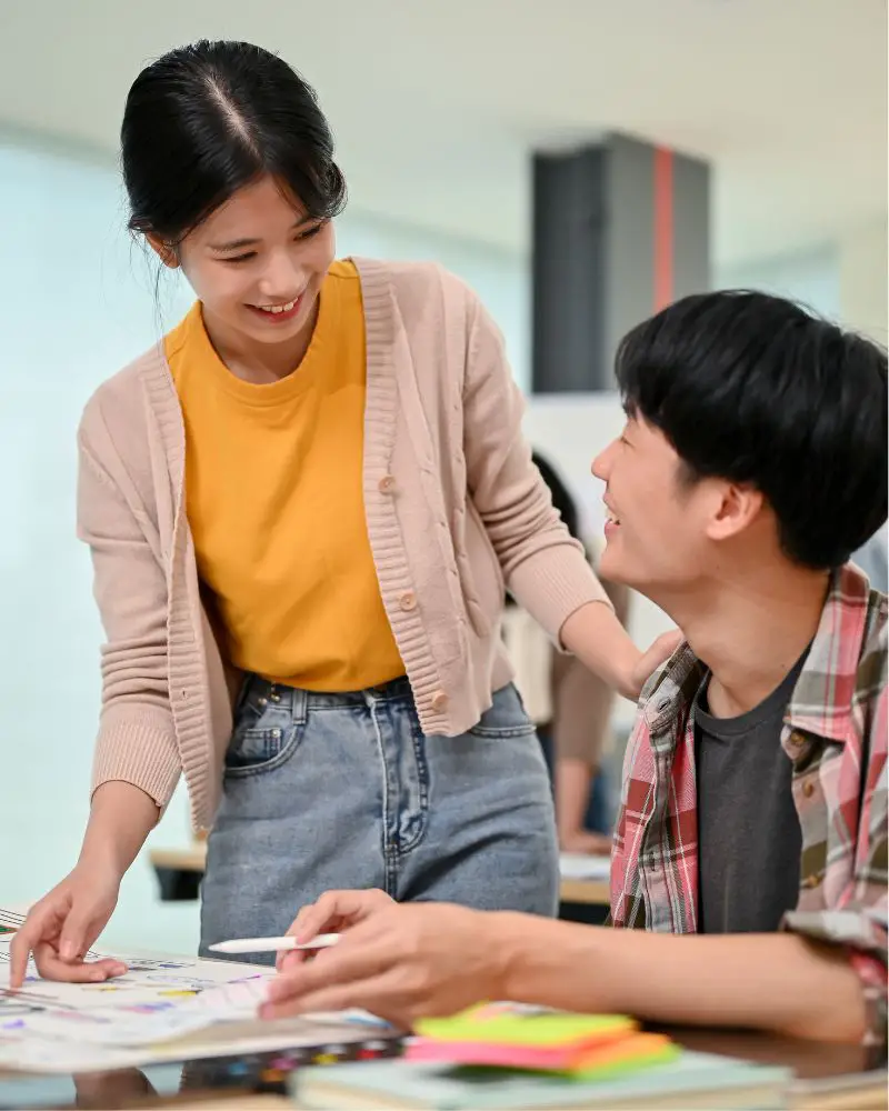 a woman tutoring a man after learning how to turn a hobby into a side hustle