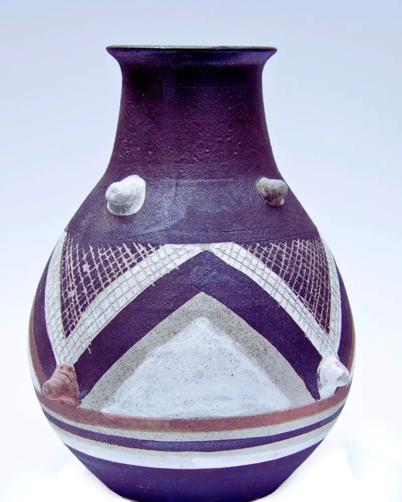 a purple and white pottery vase that could be interesting to someone who wants to know how to tell if pottery is valuable