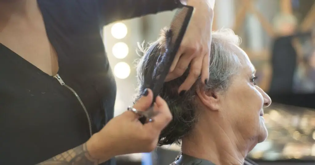 a woman getting her hair cut