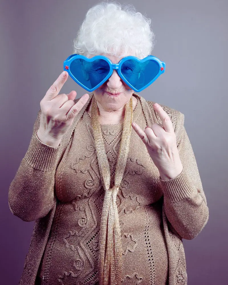 an old woman wearing heart shaped sunglasses