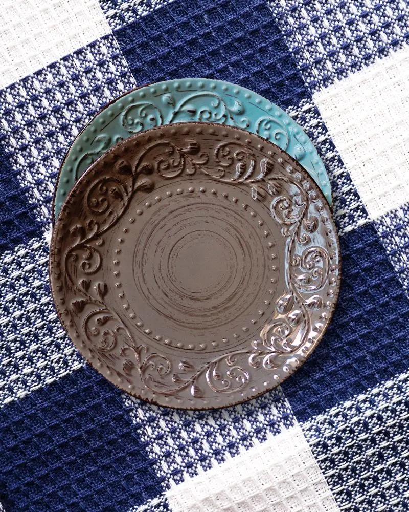 a brown and blue plates on a blue and white checkered cloth