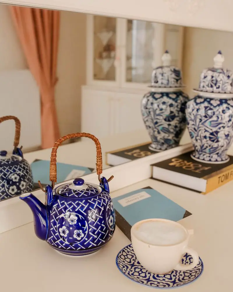 a teapot and a cup on a table