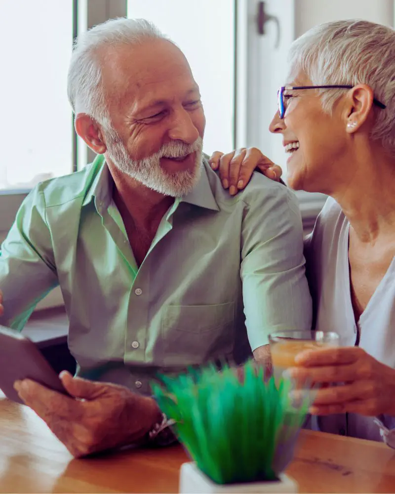 a man and woman smiling at each other after discovering the joy of dating a widower over 50