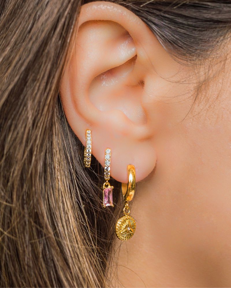 a close up of a woman's ear to demonstrate the options of ear piercing over 50