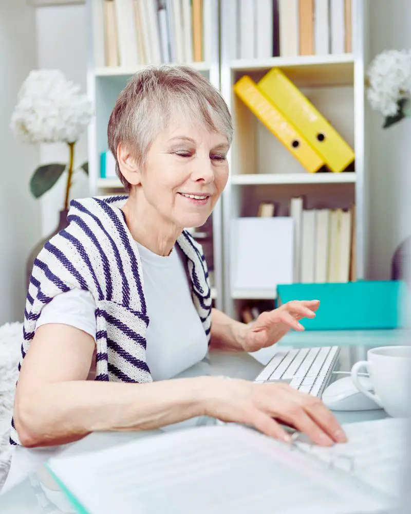 a woman sitting at a desk using a computer