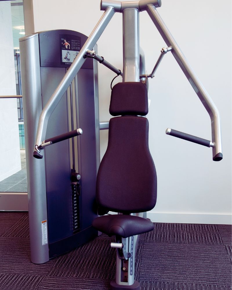 a gym machine with a black seat demonstrating the best exercise equipment for over 60