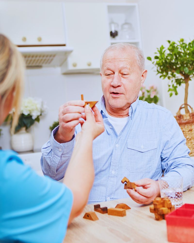 a man and woman playing with wooden blocks after asking the question can you develop ADHD later in life