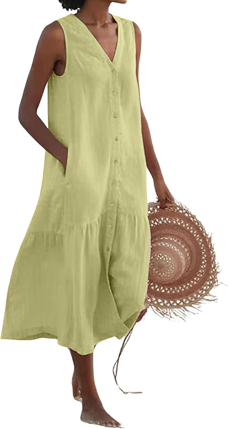 a woman holding a straw hat wearing a linen tank dress to demonstrate summer dresses for women over 50