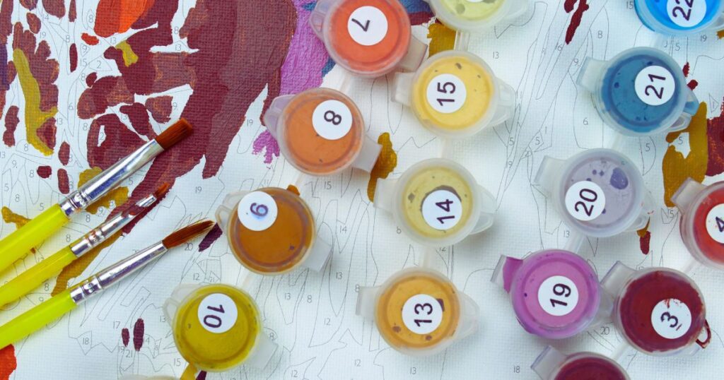 paint in containers with numbers on a canvas so that you can create your own color by number