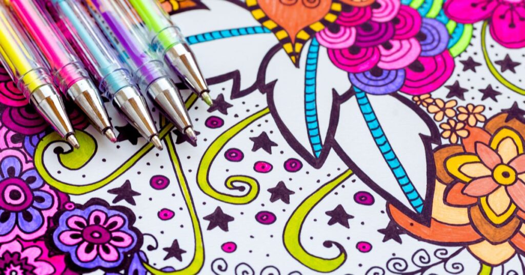 a group of pens on a coloring book to accompany adult coloring tuturials