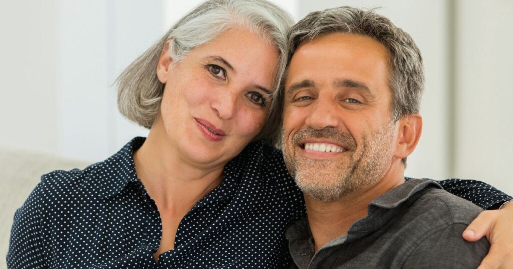 a man and woman smiling for a picture