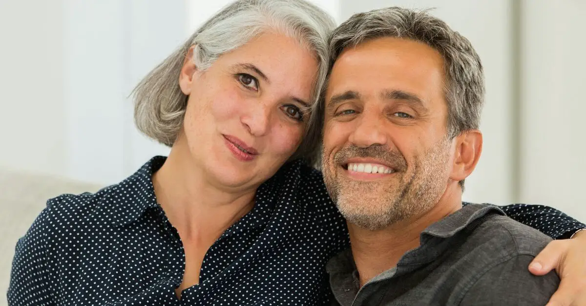 a man and woman smiling for a picture