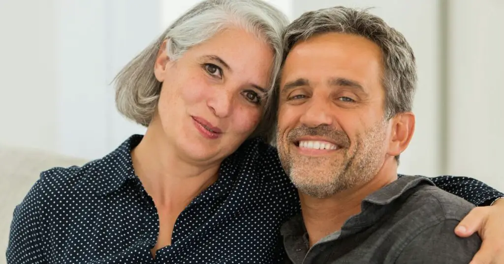 a man and woman smiling for a picture after surmounting the obstacles of dating a widower over 50