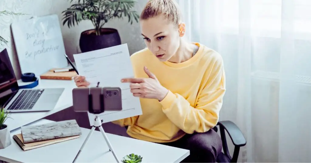 a woman pointing at a paper