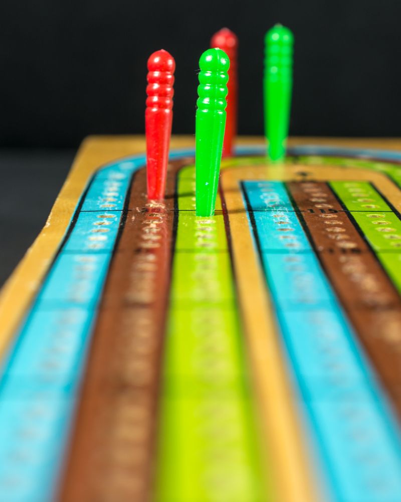 a colorful cribbage board game with pegs made using a cribbage board printable