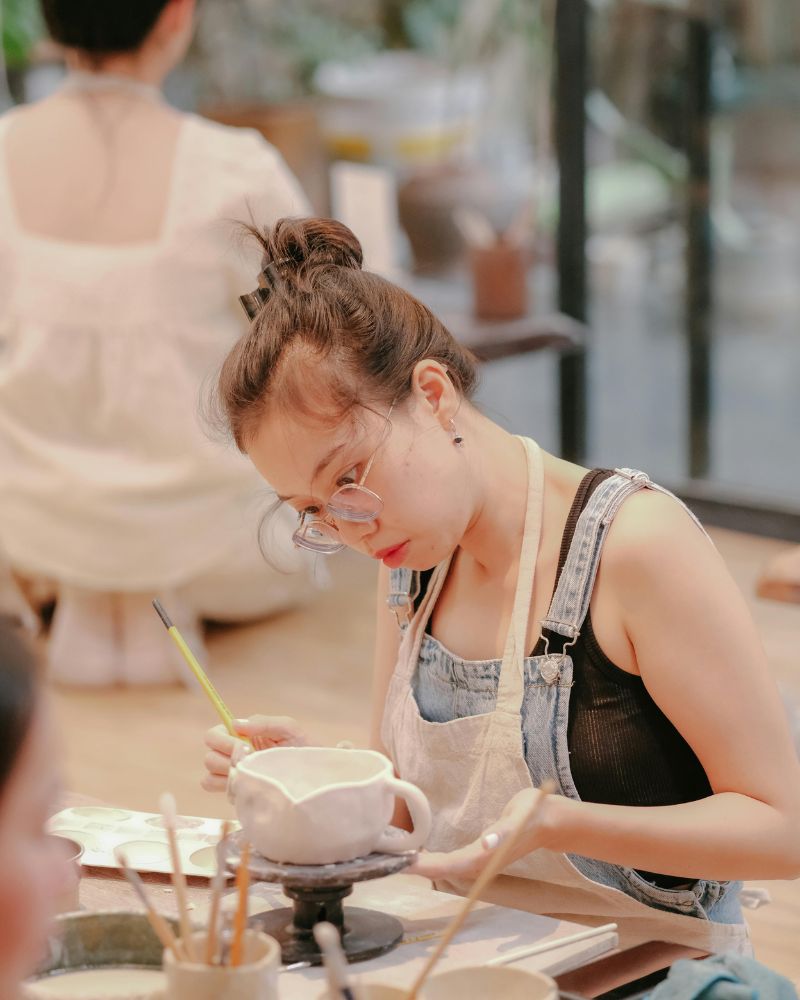 a woman painting a cup for ceramics are dishwasher safe