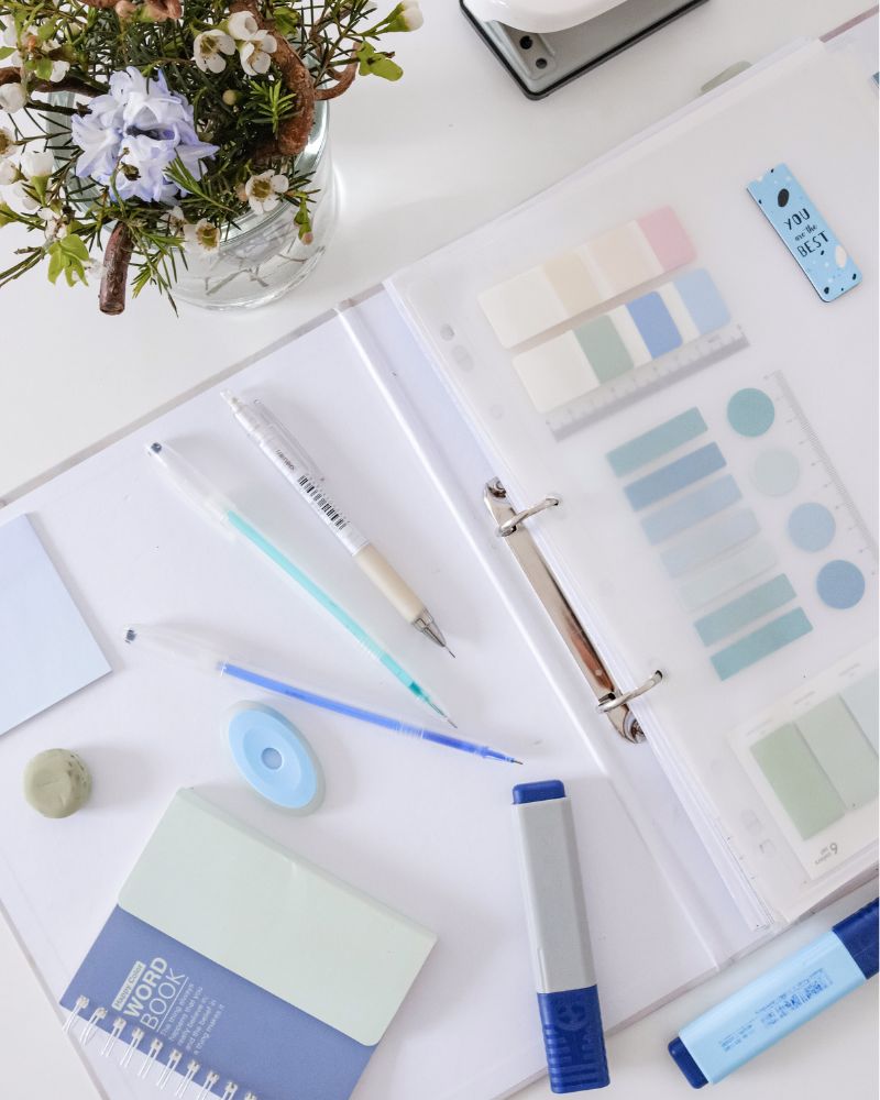 a white and blue stationery on a white surface demonstrating a planner for writers