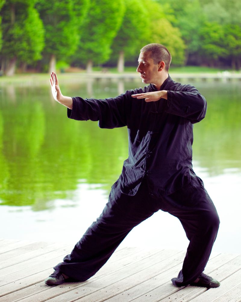 a man in black clothes doing tai chi exploring the best martial arts for seniors