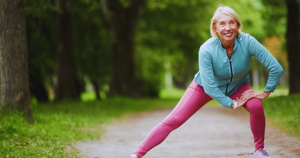 a woman stretching her leg wearing leggings for women over 60